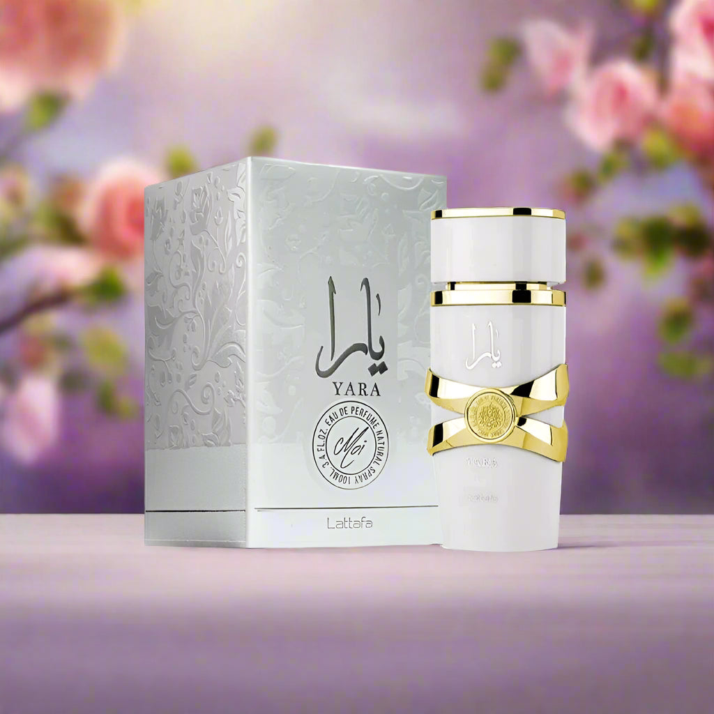 White perfume bottle with gold accents and matching box on a white background
