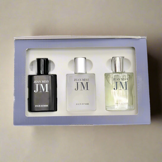 Three Jean Miss JM perfume bottles in a box on a textured surface
