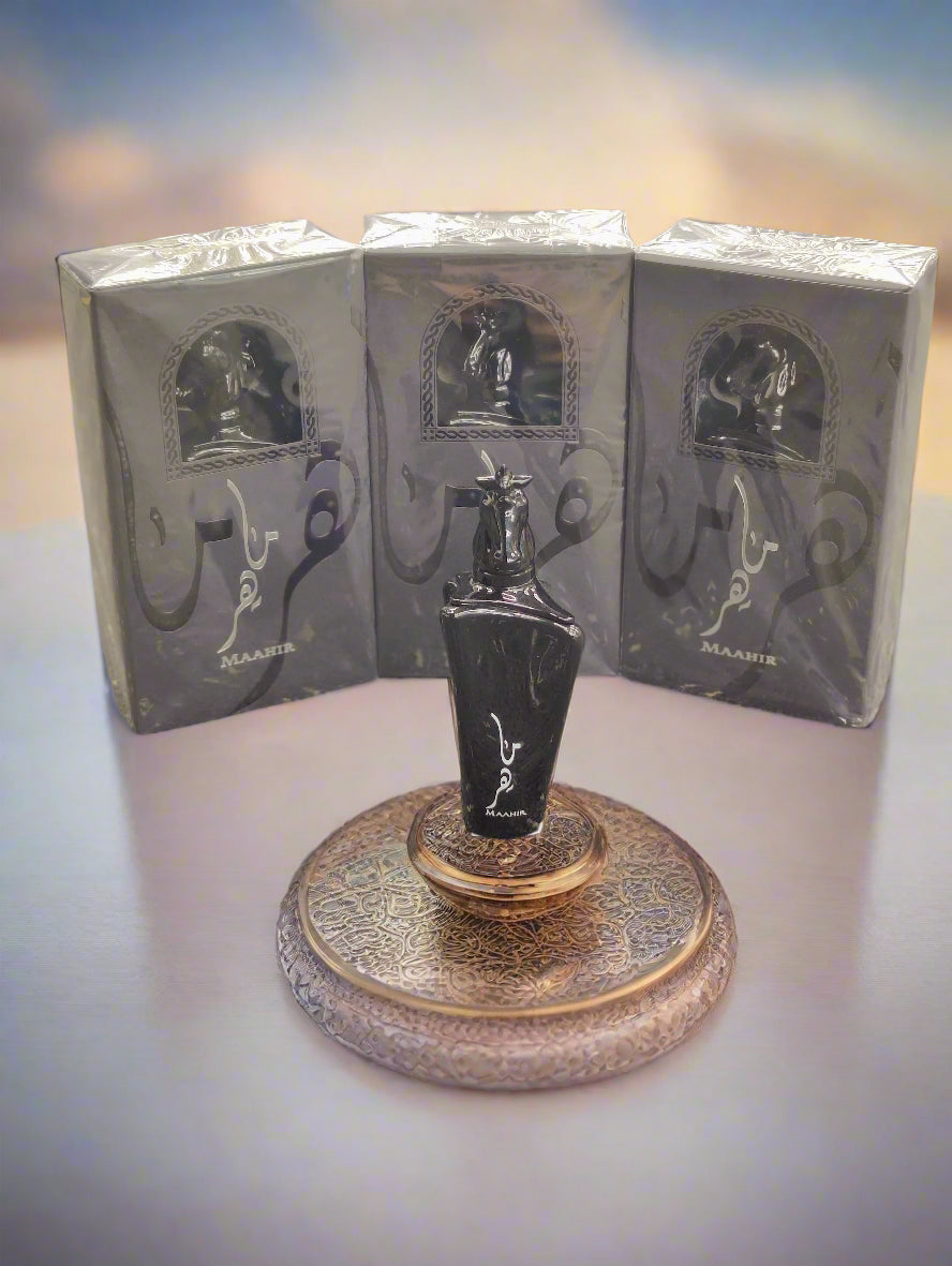 Black perfume bottle with packaging on a textured surface