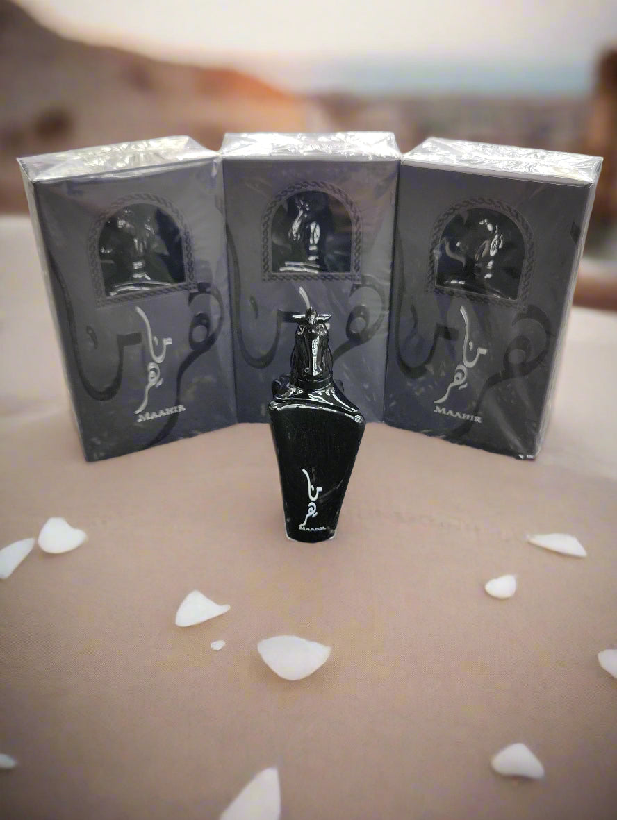 Black perfume bottle with packaging on a textured surface