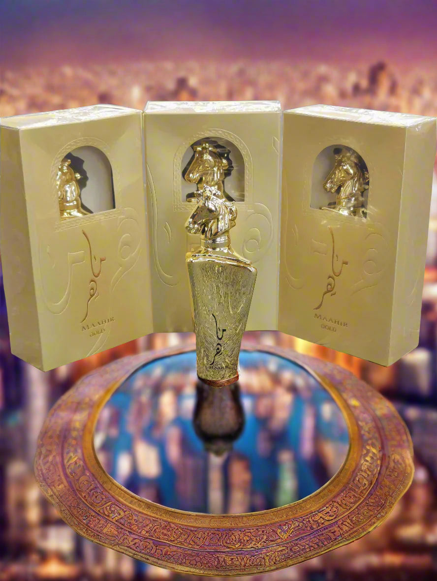 Gold perfume bottle with packaging on a textured surface