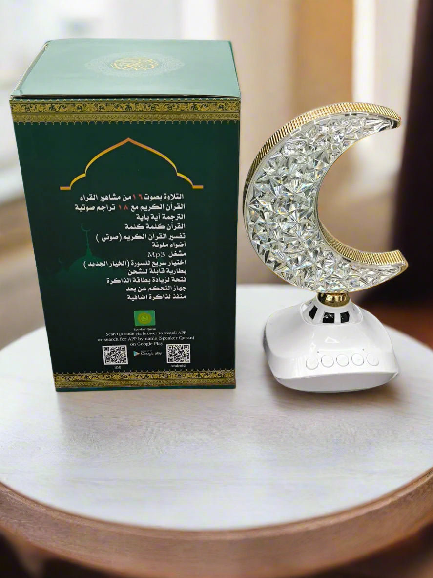 Decorative lamp shaped like a crescent moon next to its packaging on a textured surface