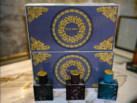 Perfume set with blue and gold packaging on a textured surface