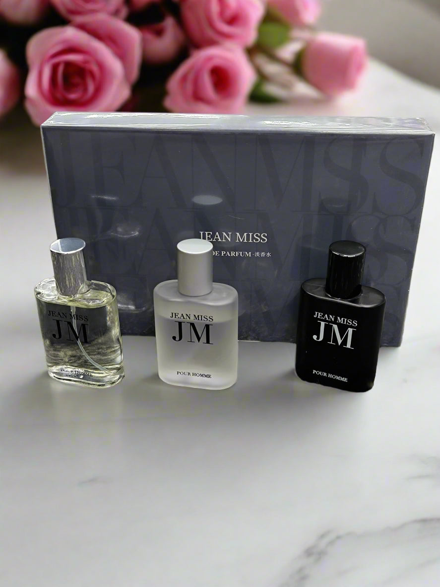 Three perfume bottles with 'Jean Miss' branding on a textured surface.
