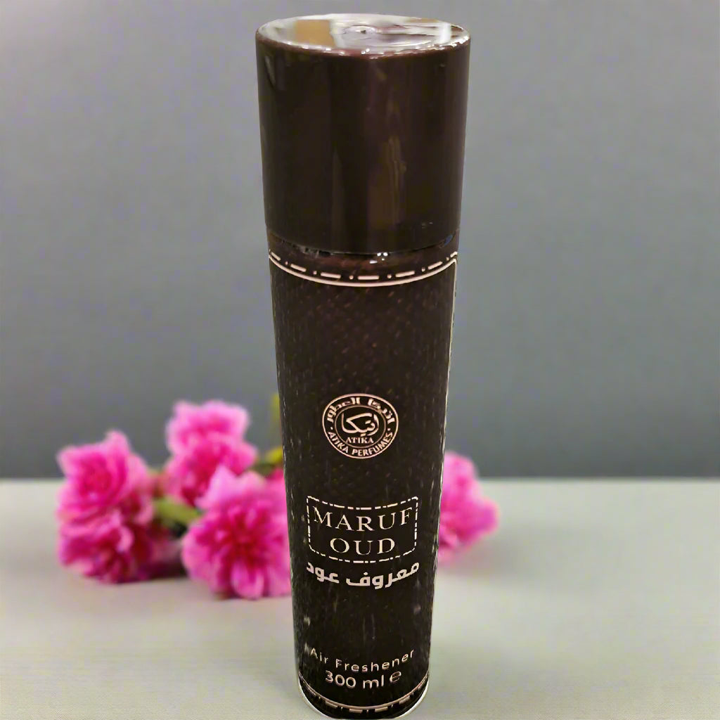 Black cylindrical container labeled 'Maruf Oud' on a textured gray background
