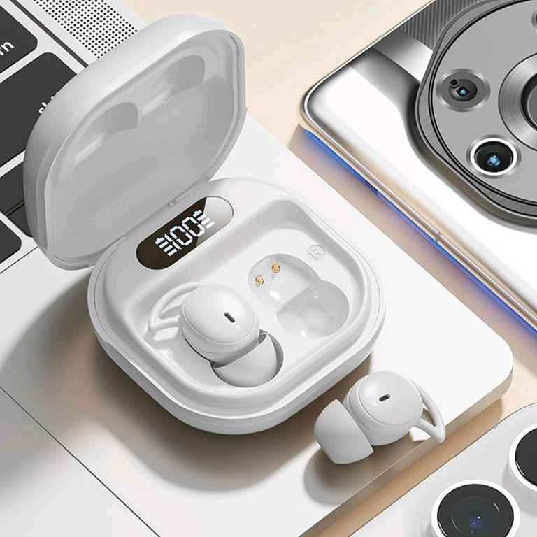 White wireless earbuds in a charging case with a smartphone in the background