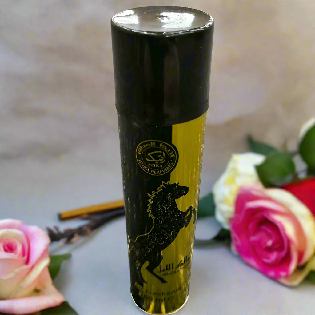 Black and yellow cylindrical product with a logo on a textured gray surface