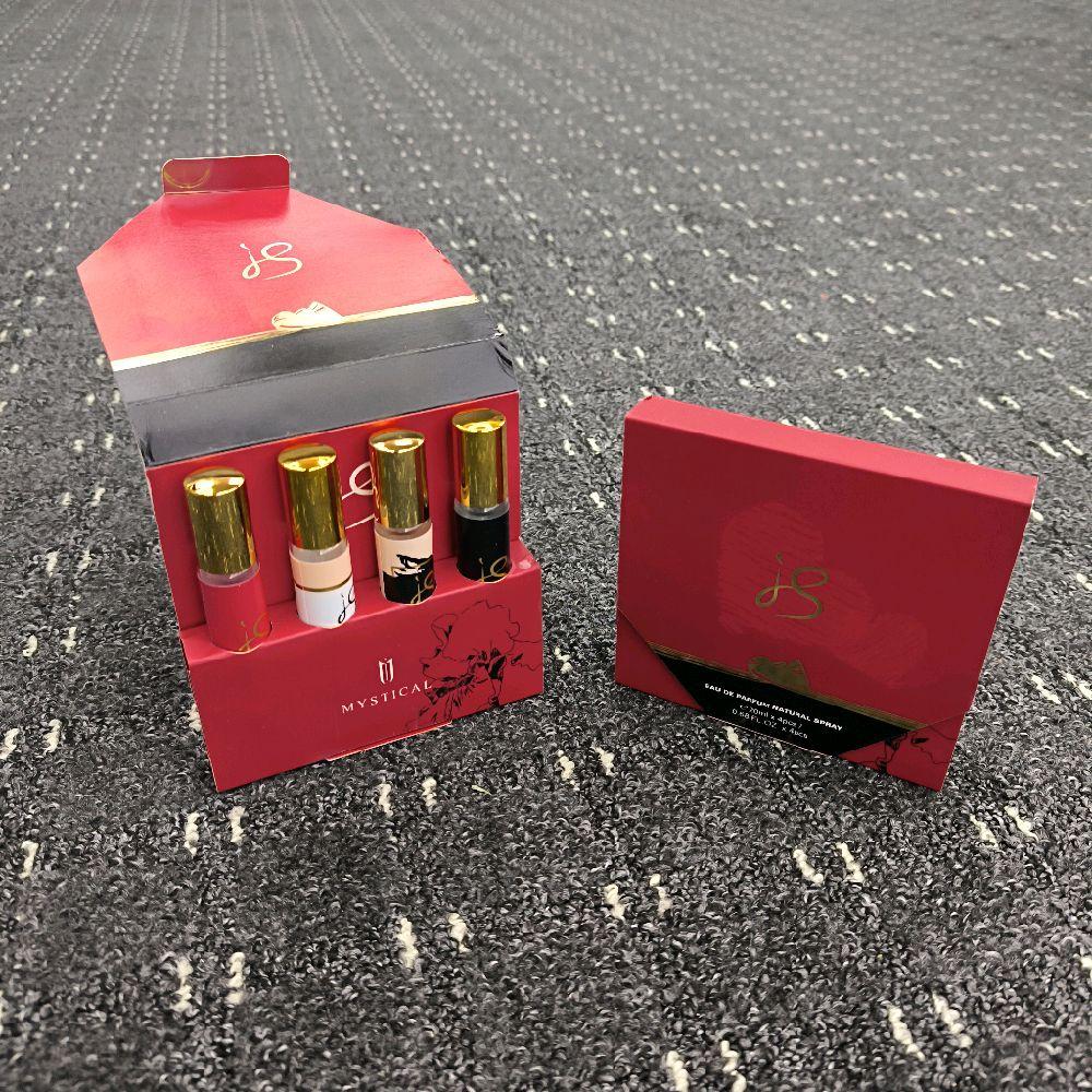 Set of lip products in a red box on a textured surface