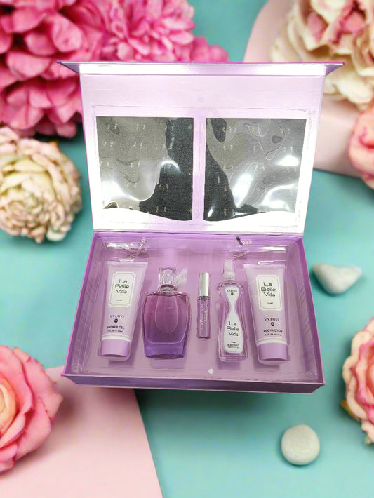 Set of beauty products in a purple box on a textured black surface