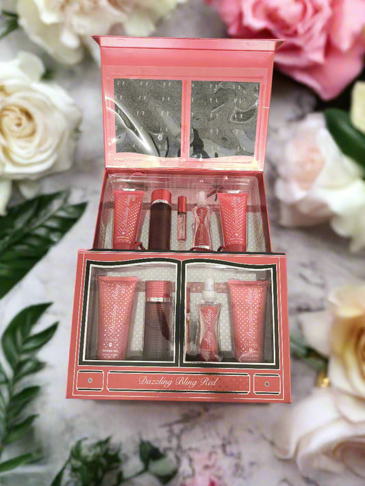 Red cosmetic set with multiple products in a box on a textured black surface