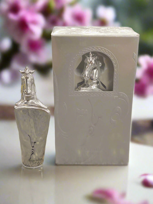 Silver religious figurine next to its packaging on a textured surface