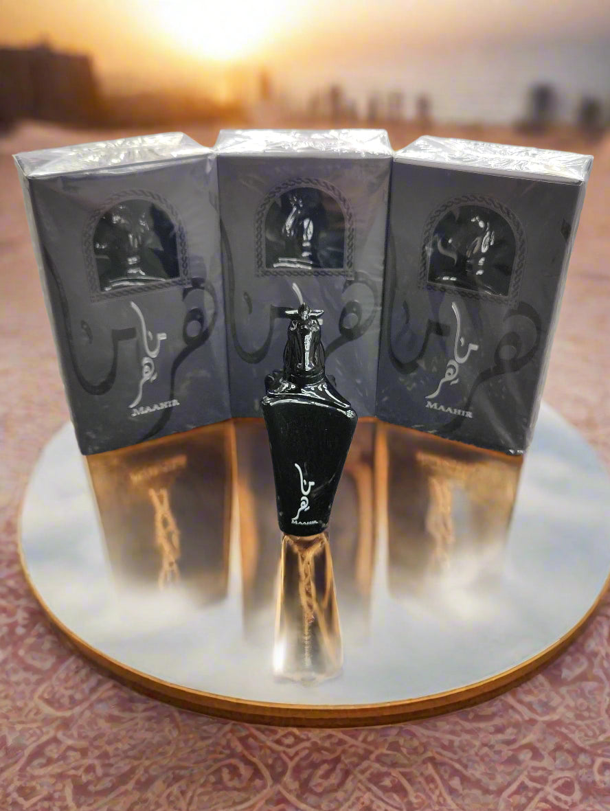 Black perfume bottle with packaging on a textured surface