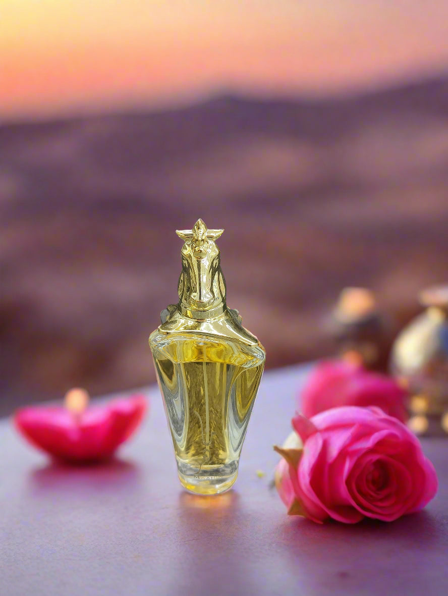 Perfume bottle with packaging on a textured surface
