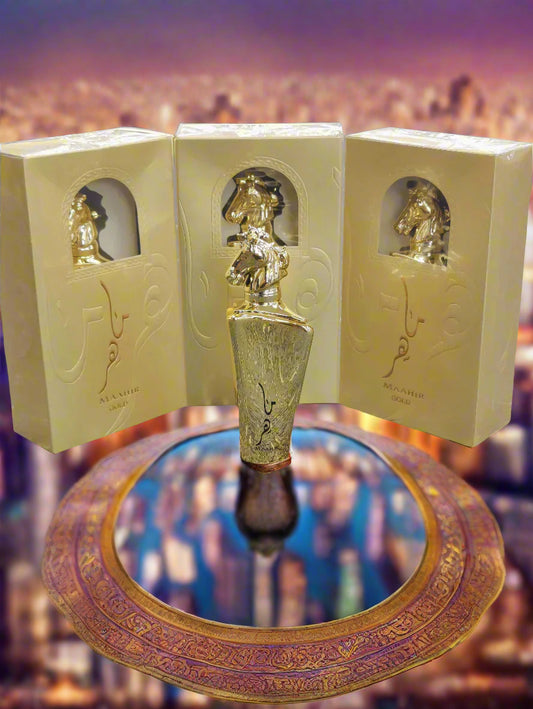 Gold perfume bottle with packaging on a textured surface