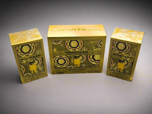 Three gold 'Phantasm' boxes on a textured surface