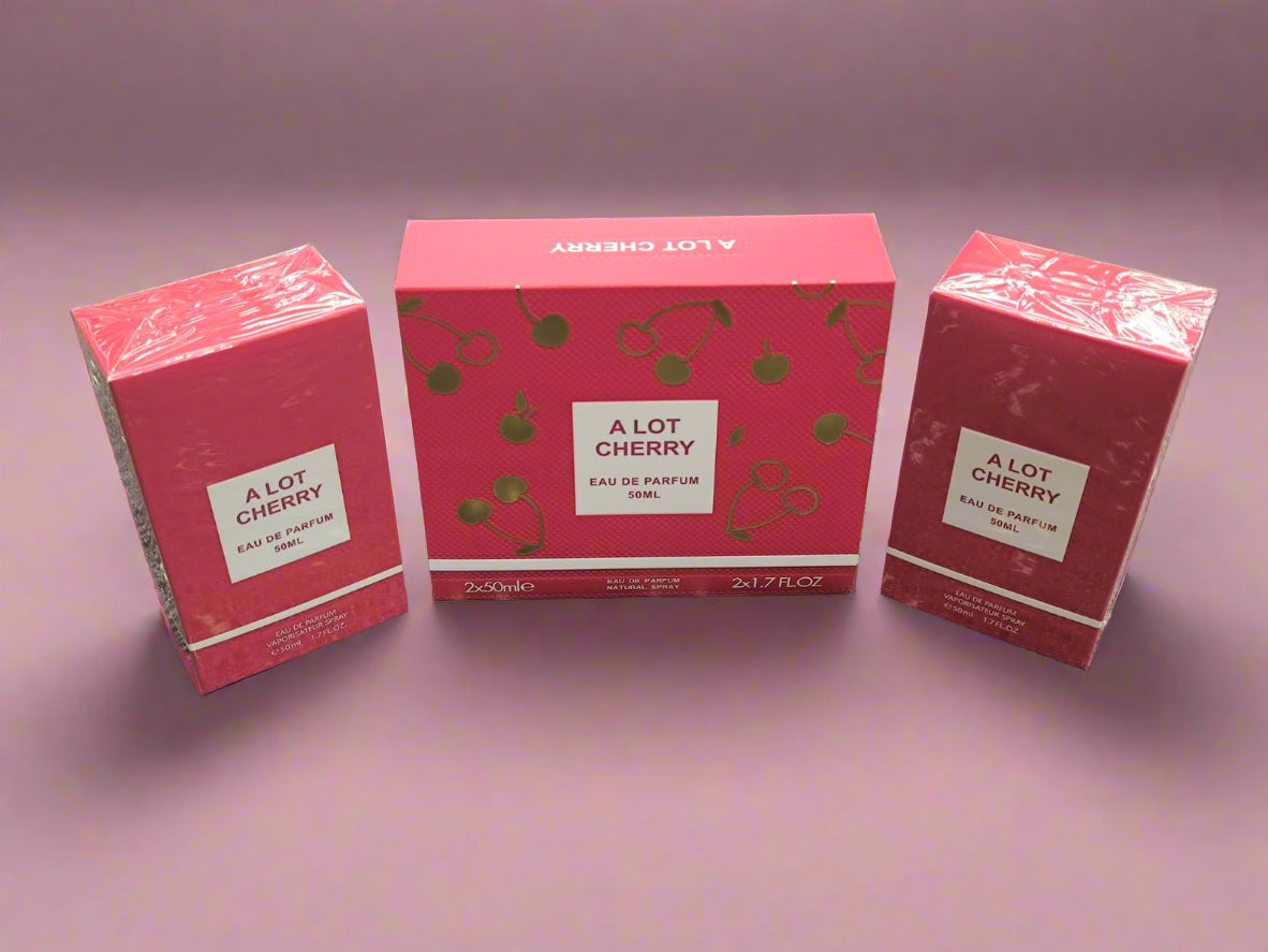 Three 'A Lot Cherry' perfume boxes on a textured surface