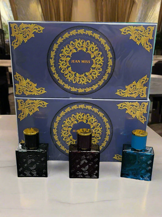 Perfume set with decorative packaging on a textured surface