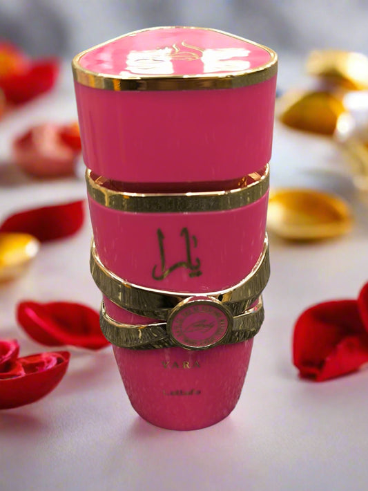 Pink cylindrical container with gold accents on a gray textured surface