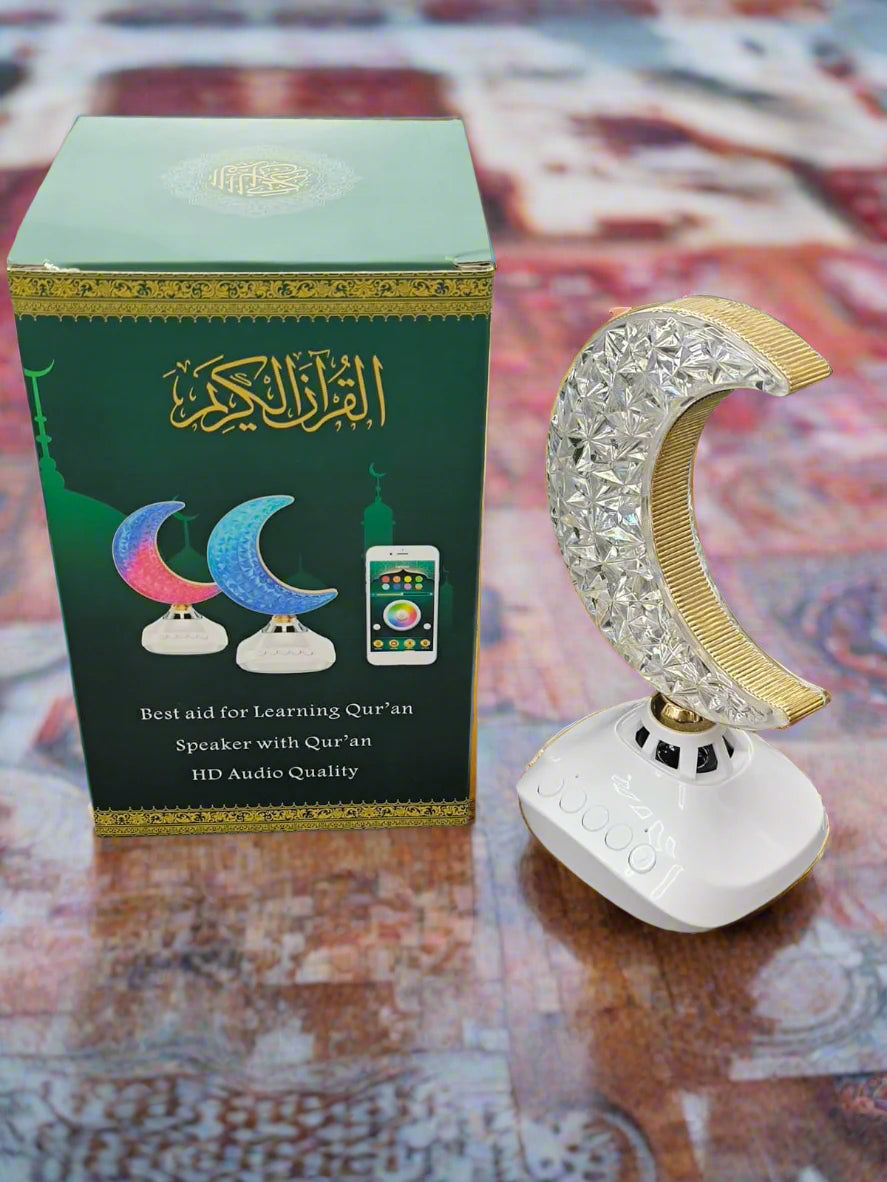 White crescent moon-shaped device with a green box on a textured surface
