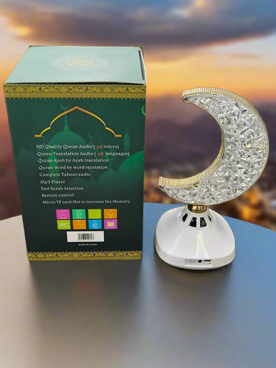 Crystal moon-shaped Quran reader with packaging on a textured surface