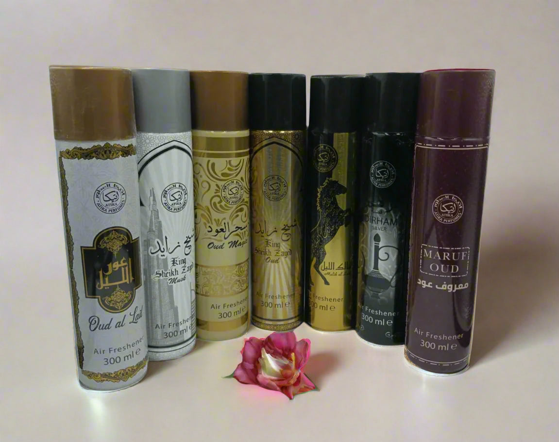 Collection of Maruf Oud perfume bottles on a reflective surface