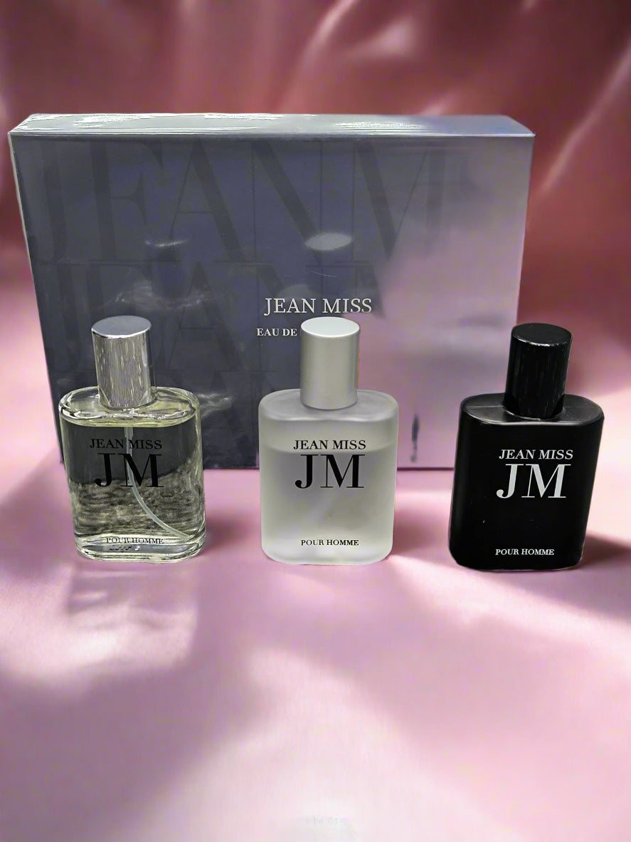 Three perfume bottles with 'Jean Miss' branding on a textured surface.