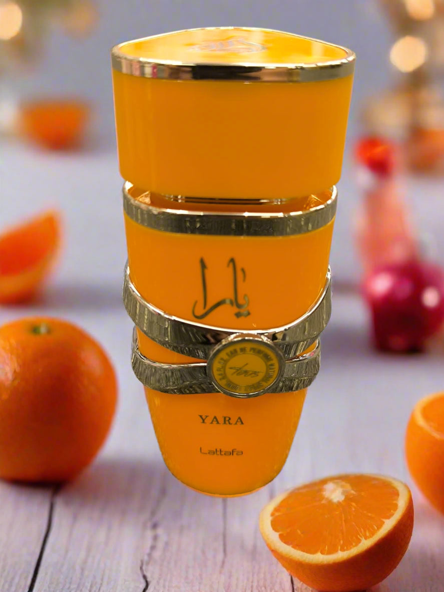 Orange candle holder with gold accents on a textured gray surface
