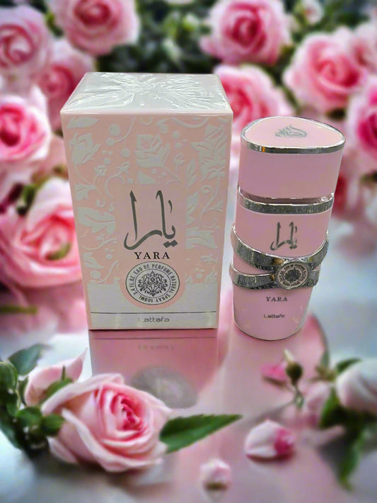 Pink Yara perfume bottle and packaging on a textured surface