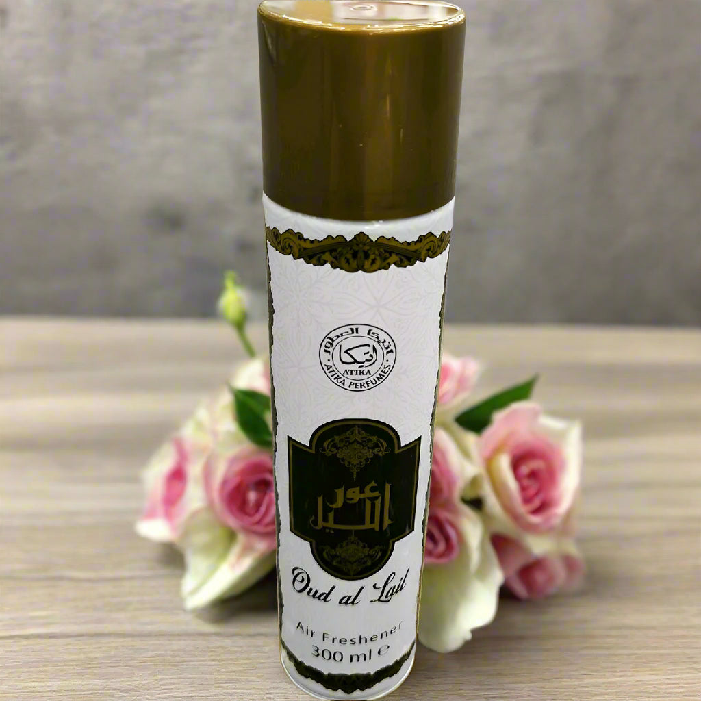 Air freshener with a gold cap and white label on a textured gray background